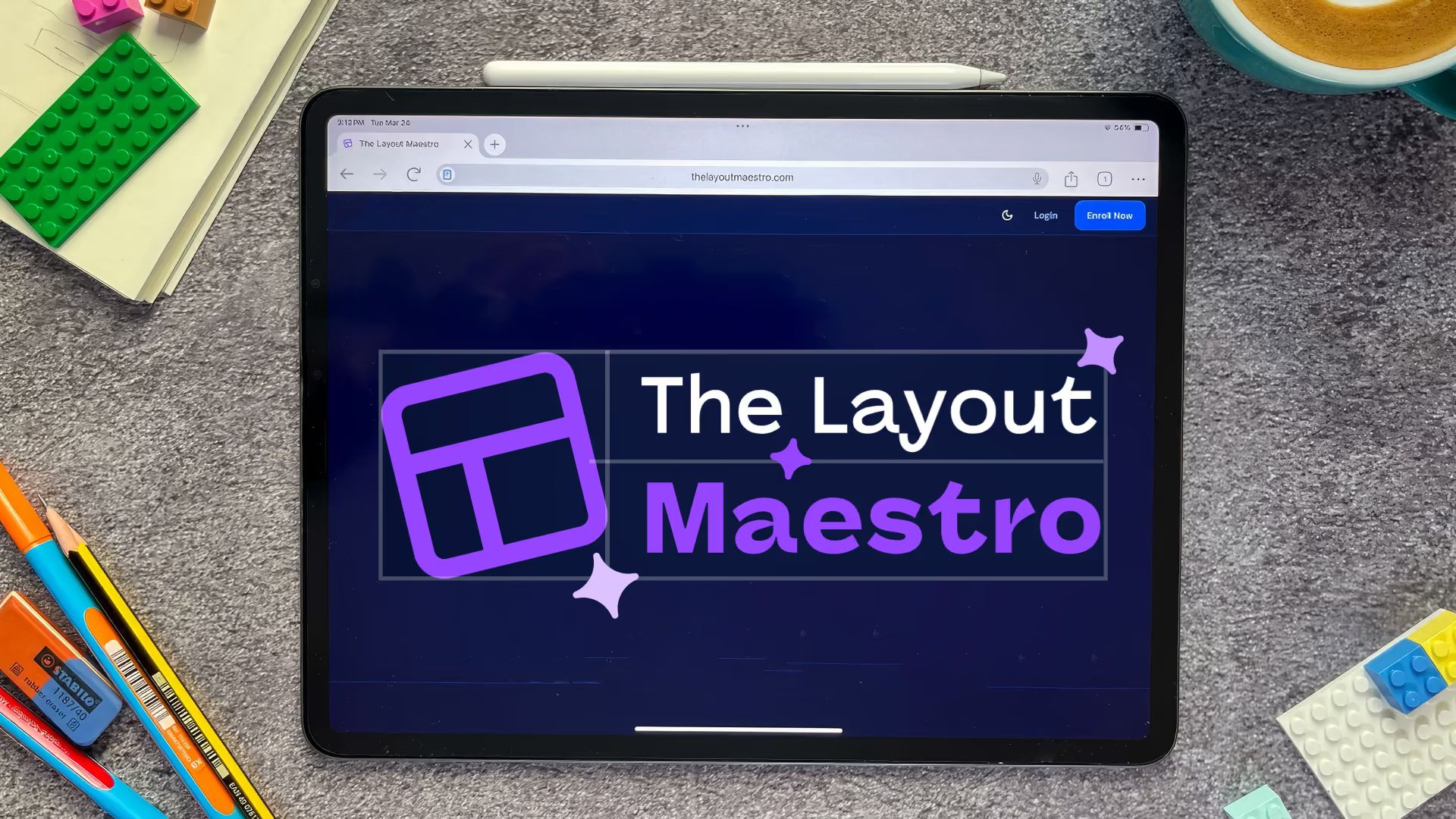 Photo of a tablet on a desk with LEGO bricks, pens, and a coffee cup. The screen shows “The Layout Maestro” with a purple grid logo.